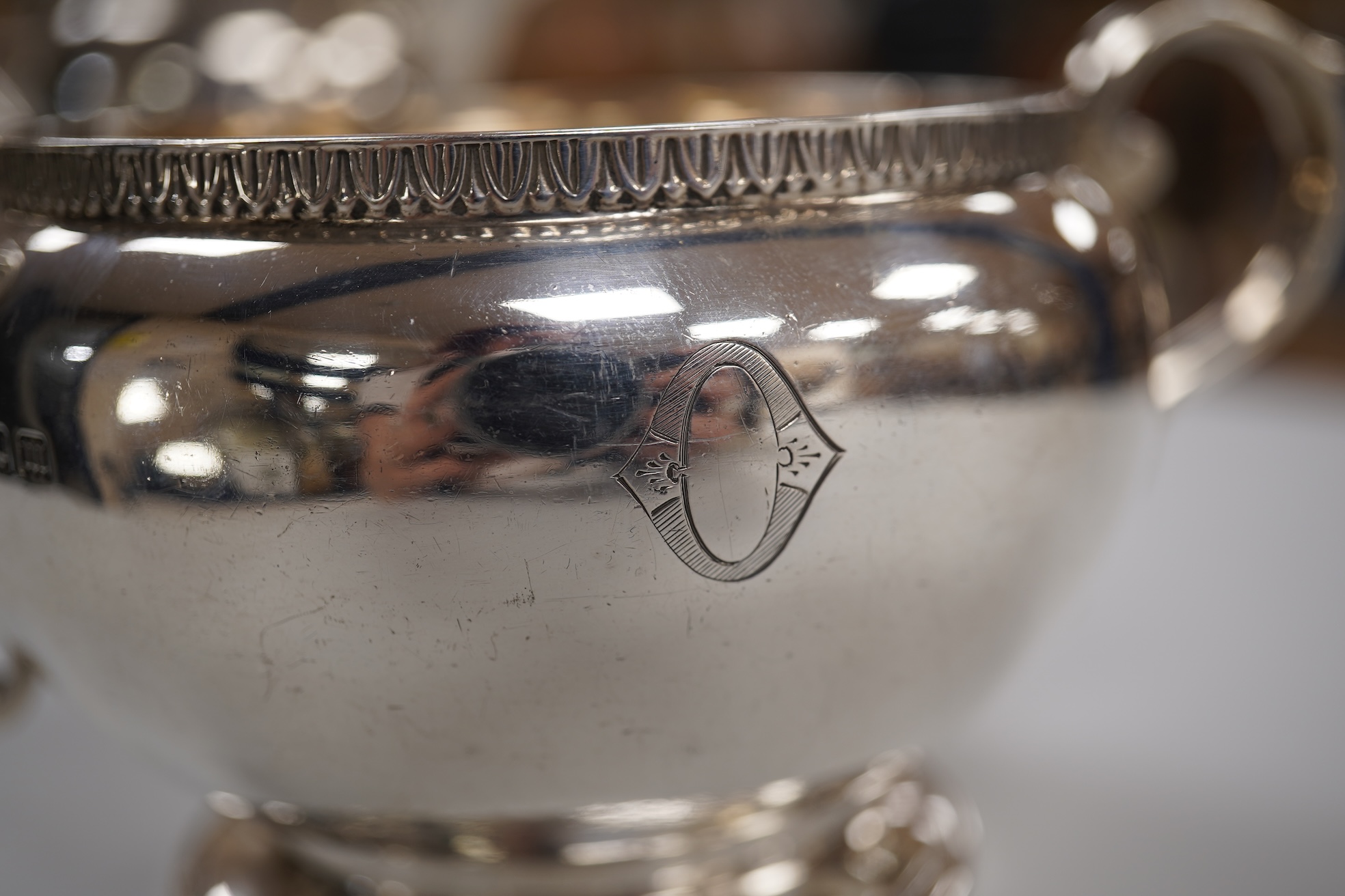 A George V silver circular three piece tea set, with engraved initial, Fenton, Russell & Co Ltd, London, 1927, gross weight 32.4oz.